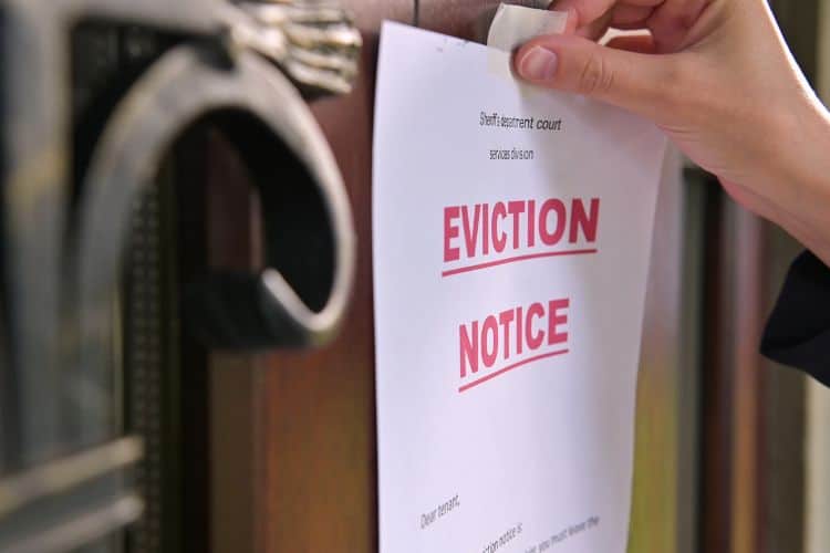 Someone Hanging Tenant’s Eviction Notice on the Door